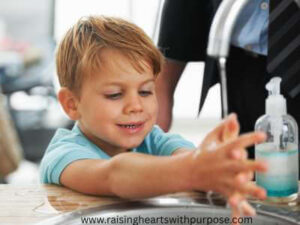 a-child-playing-with-water-in-a-sink